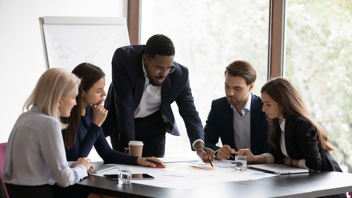 a group of corporates studying a business case on the combination of MuleSoft Anypoint community manager and Microsoft co pilot for api integrations